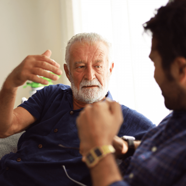 Older man discussing finances with his son